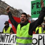 Macron Pledges to Prevent Riots as Yellow Vests Plan Major Paris March