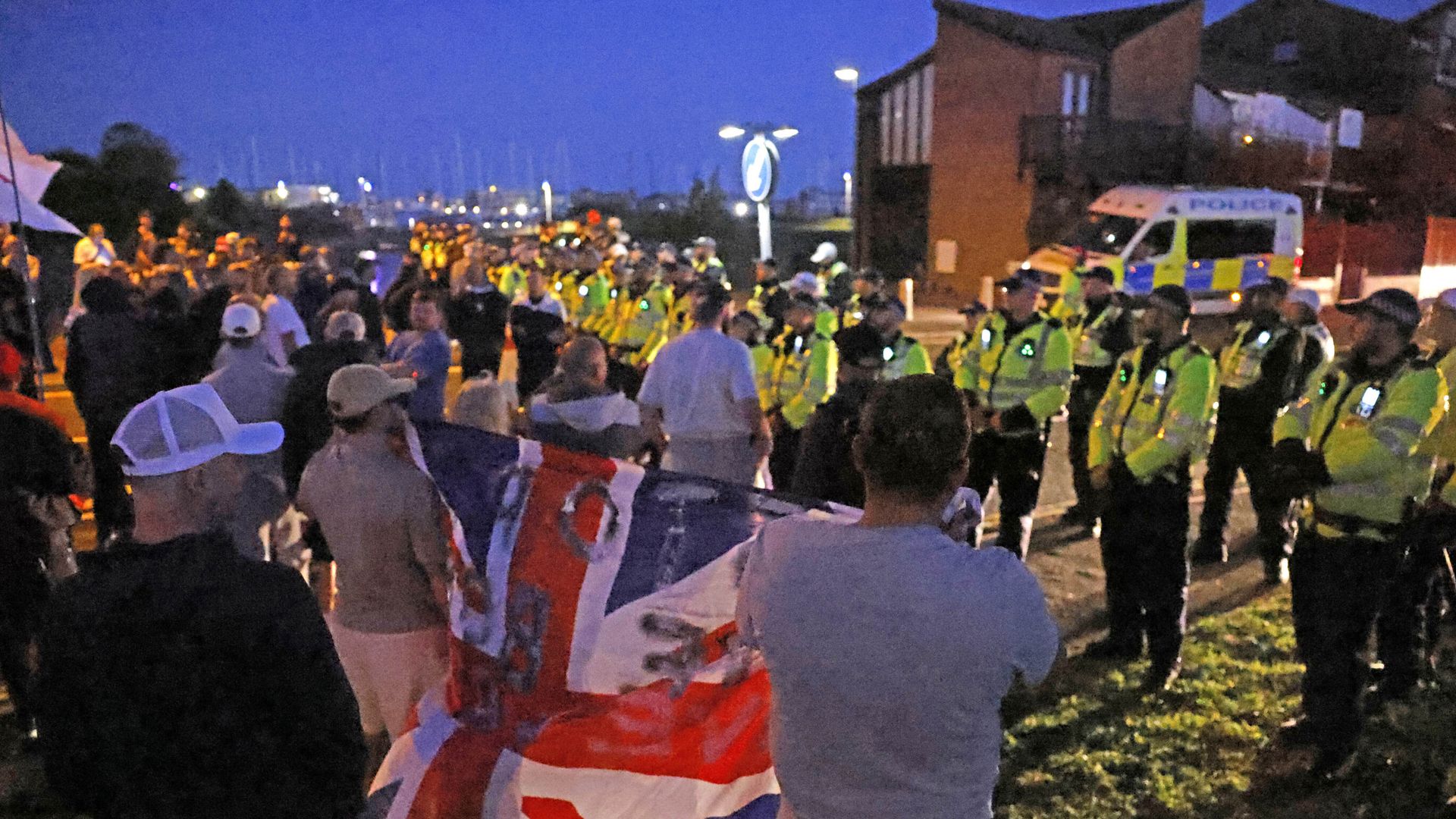 Anti-Migrant Demonstrators Assemble in Hampshire as Migrant Boat Reaches UK Coast